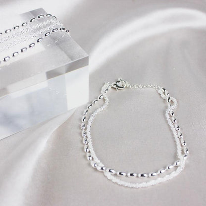 Sølvfarvet armbånd med zirconia
